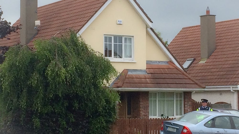 Forensic investigators carry out an examination of the house