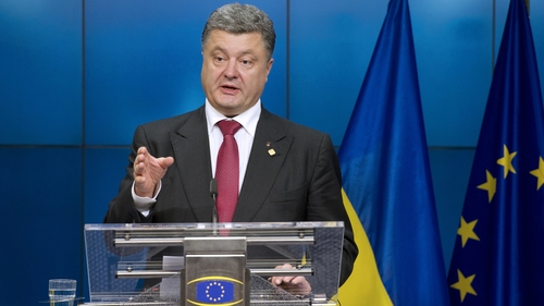 Petro Poroshenko yesterday signed a landmark free-trade deal at a European Union summit