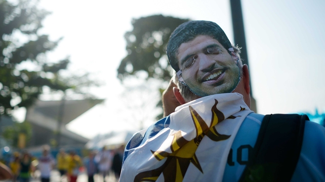 A Uruguay supporter sported a mask of disgraced striker Luis Suarez, who was banned for the duration of this World Cup and beyond after allegedly biting an opponent during Uruguay's final Group D match against Italy