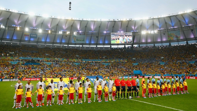 And both teams lined up to sing their anthems with gusto under the bright lights