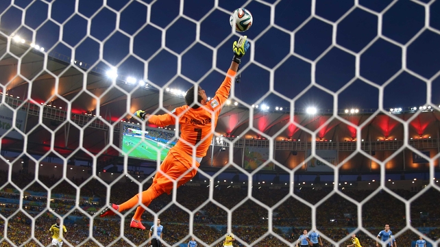 At 28' Colombia's rising star midfielder James Rodriguez handled and rocketed what may be the goal of the tournament so far past Uruguay keeper Fernando Musalera
