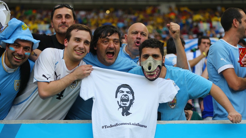 Uruguay fans holds up a t-shirt of Luis Suarez ahead of the 2014 FIFA World Cup Brazil round of 16 match between Colombia and Uruguay