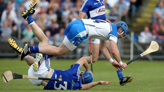 Waterford's Shane Walsh with Brian Campion of Laois take a tumble