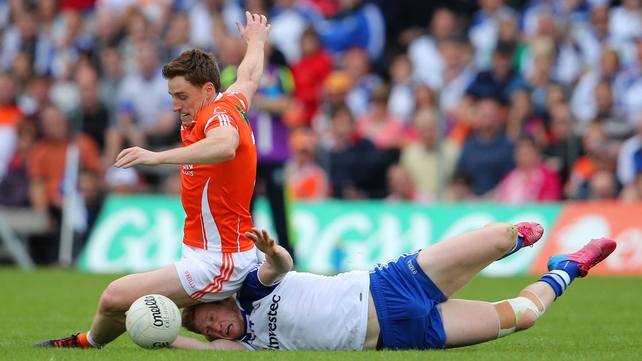 Armagh's Charlie Vernon takes a seat as he and Kieran Hughes of Monaghan go for the ball