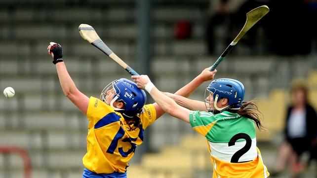 Clare's Claire McMahon and Fiona Stephens of Offaly battle for the sliotar during their championship clash