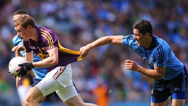 Dublin's Rory O'Carroll seems keen that Kevin O'Grady of Wexford not get too far too fast