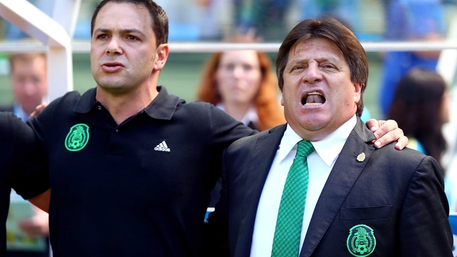 Mexico's boisterous coach Miguel Herrera (R) joined in his country's national anthem