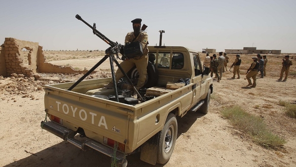 Iraqi troops monitor an area west of the shrine city of Karbala in central Iraq yesterday