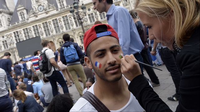 A France fan in Paris, looking ahead to both of the day's fixtures, had the French and Algerian flags painted on his face ahead of watching Le Bleus