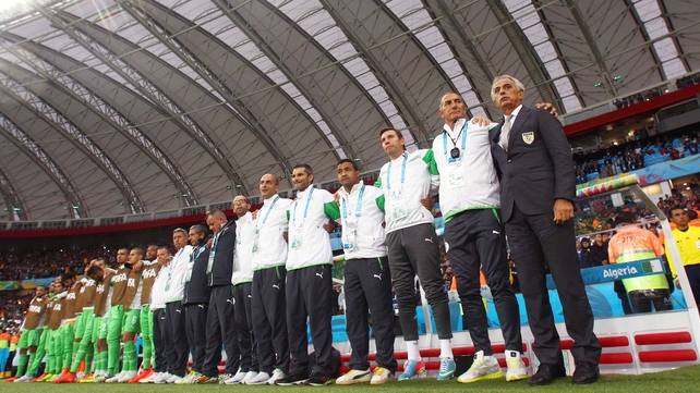 The Algeria bench, headed by coach Vahid Halilhodzic (R) joined in singing their country's national anthem
