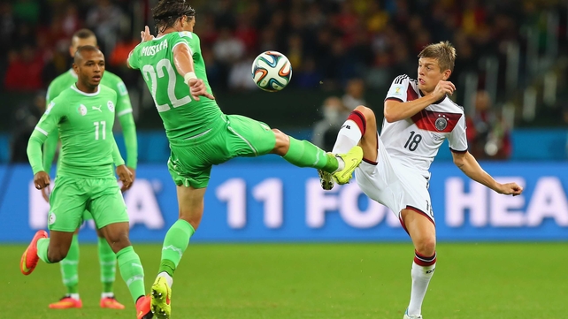 Algeria midfielder Mehdi Mostefa and Germany midfielder Toni Kroos vied for the ball in what continued to be an even contest