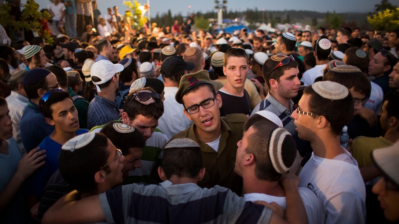 Mourners at the funerals of the three young Israelis today