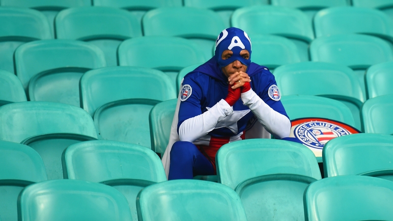 A dejected USA fan after his team's World Cup exit to Belgium