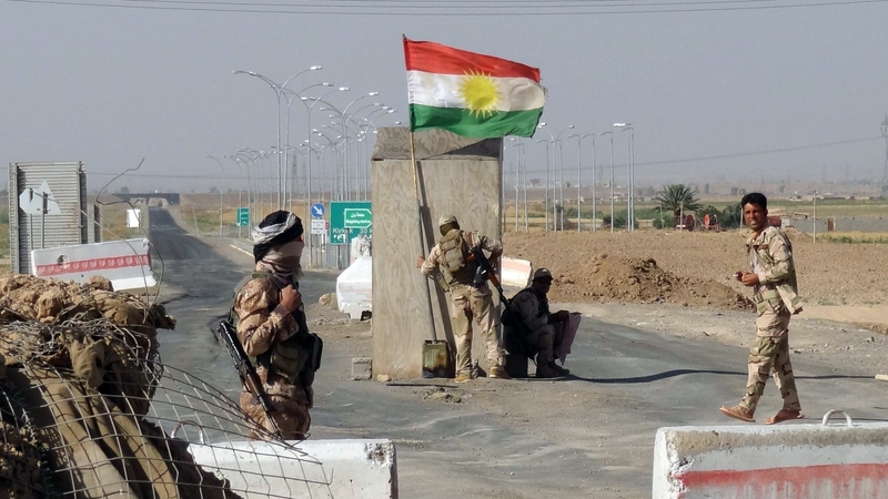 Kurdish Peshmerga forces man a checkpoint on the road leading from Kirkuk to northern Iraqi city of Tikrit