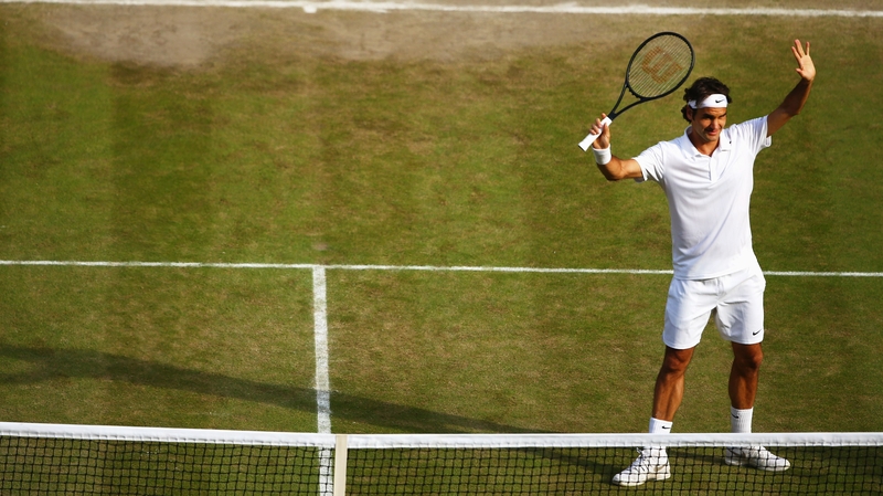 Roger Federer celebrates after beating Milos Raonic
