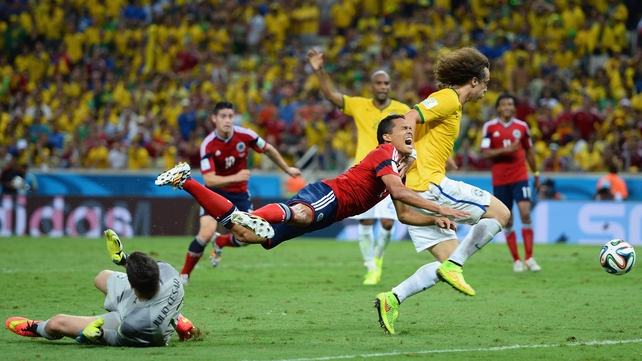 Goalkeeper Julio Cesar fouls Carlos Bacca of Colombia and concedes a penalty