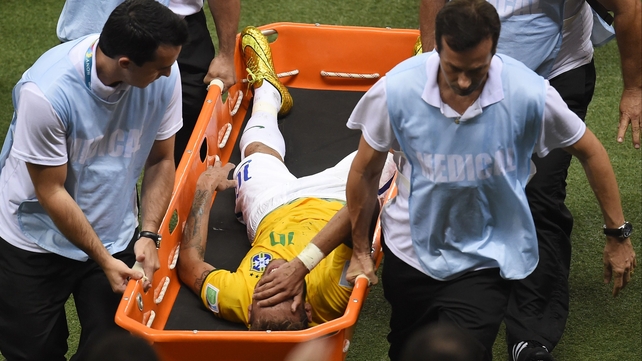 Brazil's star forward Neymar is carried off on a stretcher