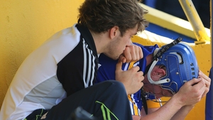 Shane O'Donnell tries to console a distraught Podge Collins after the latter was red-carded