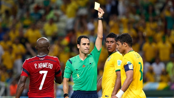 Thiago Silva is shown a yellow card against Colombia