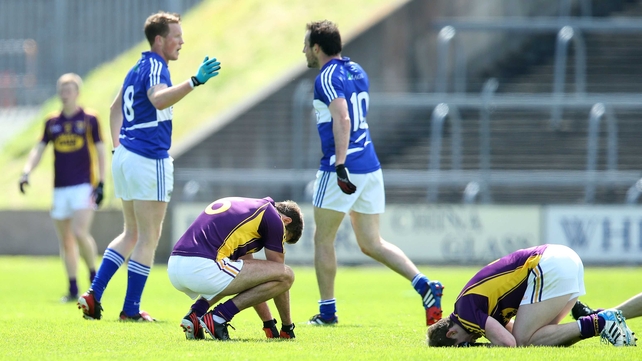 In Wexford Park, Robert Tierney and Brian Malone are dejected at the final whistle - their season is now over
