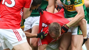 Cork's Brian Hurley with Kerry players during the final moments of the match