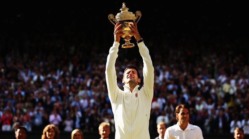 Novak Djokovic holds the Wimbledon trophy aloft after beating Roger Federer in the 2014 final