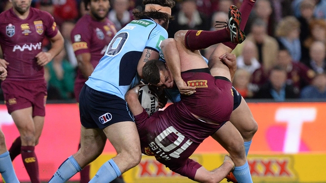 Nate Myles of the Maroons is picked up in the tackle by Greg Bird of the Blues during game three of the State of Origin series