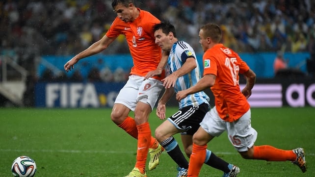 Netherlands striker and captain Robin van Persie vied with Messi for the ball