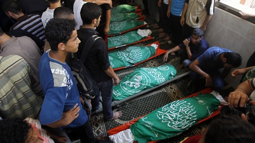 Relatives and friends of al-Hajj family gather in a mosque to pray over the bodies of the eight family members during their funeral in Khan Yunis