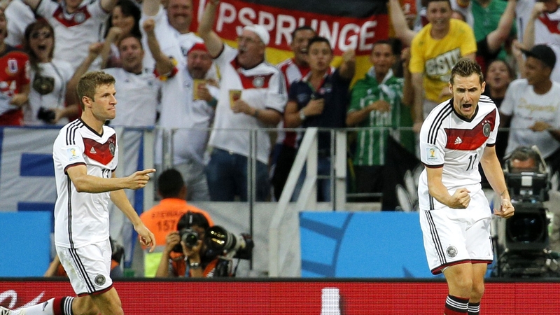 Miroslav Klose celebrates scoring with Thomas Mueller during Germany's against Ghana