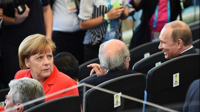 Germany's chancellor Angela Merkel looked a bit left out, sitting next to FIFA president Sepp Blatter and Russian President Vladimir Putin - who acted like regular ole chums