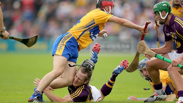 Crash: Wexford's Liam Og McGovern loses his helmet in a collision with Jack Browne of Clare