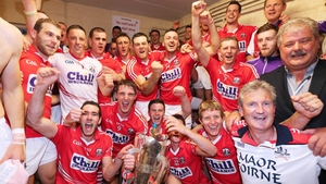 The Cork team celebrate with the Munster SHC trophy