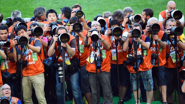 A horde of professional photographers swelled as the minutes until the match winded down