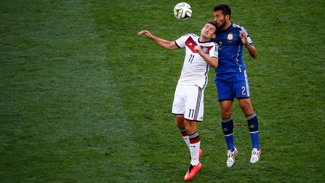 While Germany forward Miroslav Klose vied with Argentina defender Ezequiel Garay on the other end