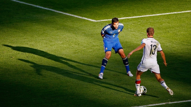 Germany's veteran forward and goal machine Thomas Mueller looked to break away from Garay in a spot of sunlight