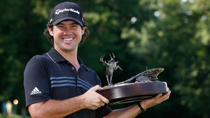 Brian Harman holds the trophy aloft
