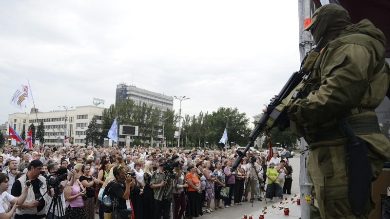 A pro-Russian militant stands guard during a rally on Lenin Square in Donetsk