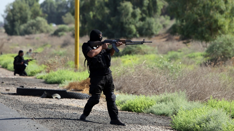 Shia volunteers, loyal to Muslim Shiite cleric Moqtada al-Sadr, take positions during a military advance in areas under the control of Islamic State