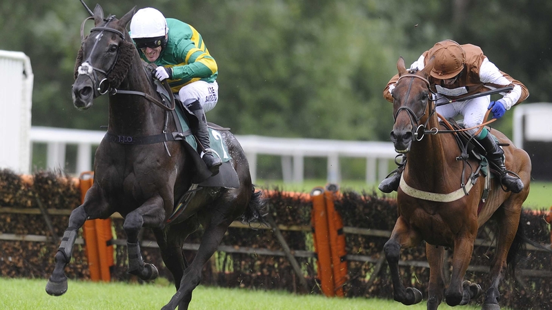 Tony McCoy riding On The Record (left) clears the last to win The 32Red On The App Store Handicap Hurdle