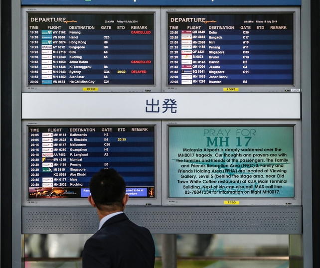 'Pray for MH17' is seen on a screen at Kuala Lumpur International Airport