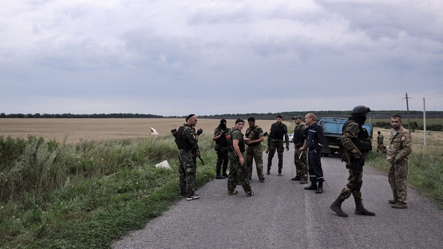 People wearing military fatigues near the site of the crash of the Malaysian airliner