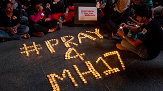 Malaysians gather during a candlelight vigil for passengers and crew of Malaysian Airline Flight MH17 in Petaling Jaya in Malaysia