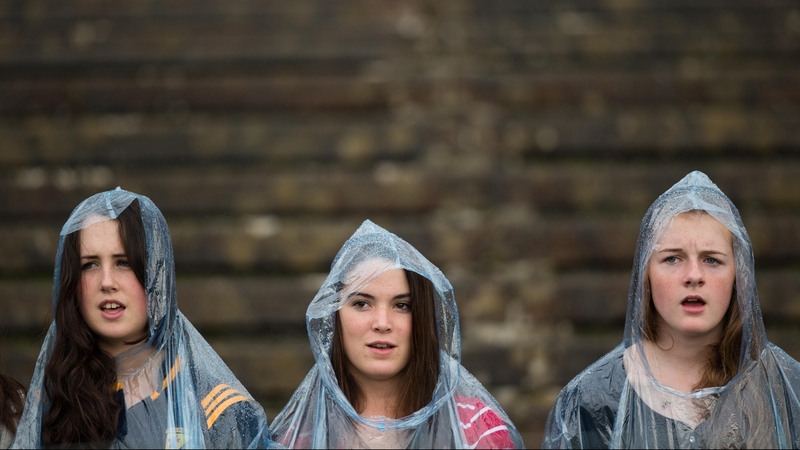Fans sing the national anthem in the rain at the Roscommon v Armagh game