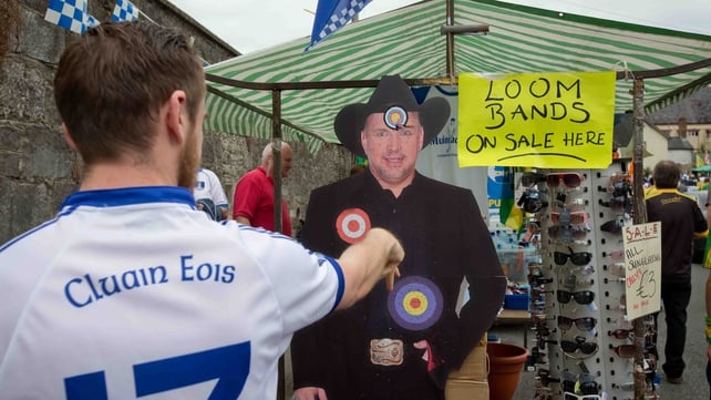 Back in Clones, Ciaran Morgan from Clones throws darts at a cardboard cutout of Garth Brooks at Clones