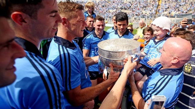 Dublin players bring the trophy to fan Molly McNally