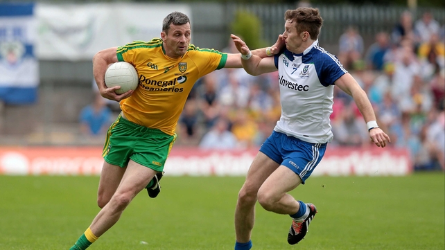 Christy Toye of Donegal holds off the challenge of Monaghan's Fintan Kelly