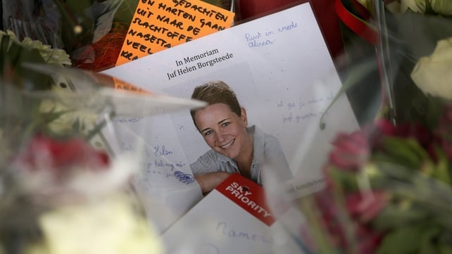A photograph of Dutch school teacher Juf Helen Borgsteede sits amongst floral tributes at Schiphol Airport