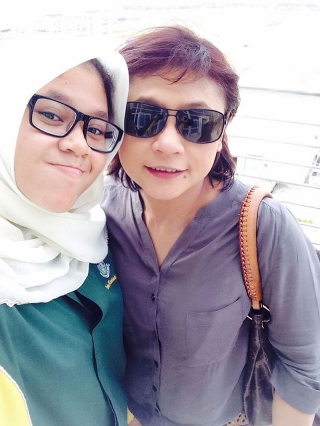 The last picture taken of Sheila Dora Kassim (R), a crew member on MH17 and her daughter, Nur Diyana Yazeera outside their home in Kuala Lumpur