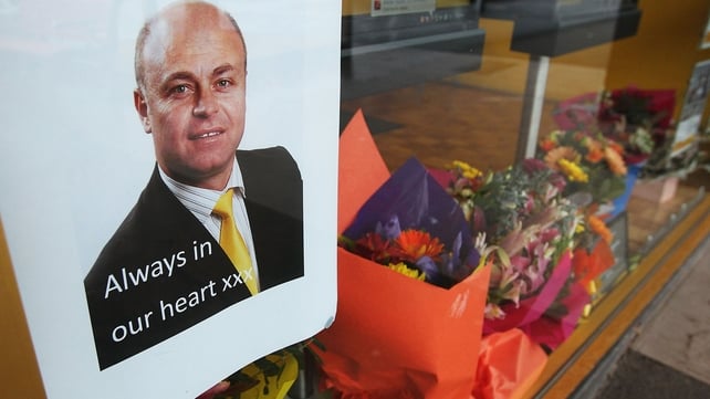 Floral tributes are seen for Albert Rizk and his wife Marie at the office where he worked in Sunbury, Australia